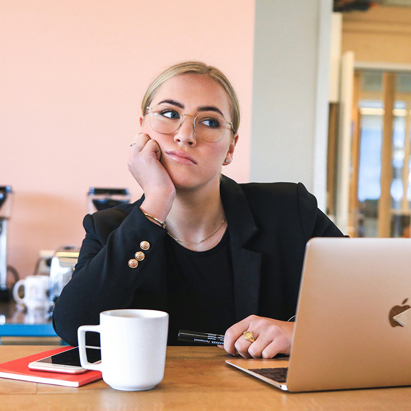 young career woman dissatisfied at a coffee shop with her laptop