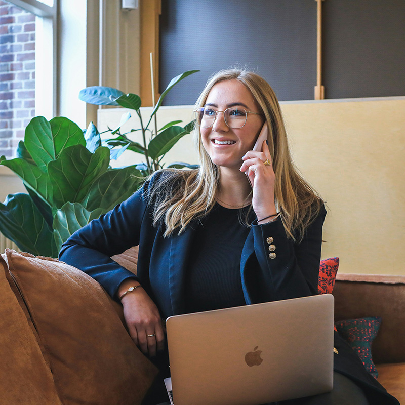 young career woman on a phone call with her laptop